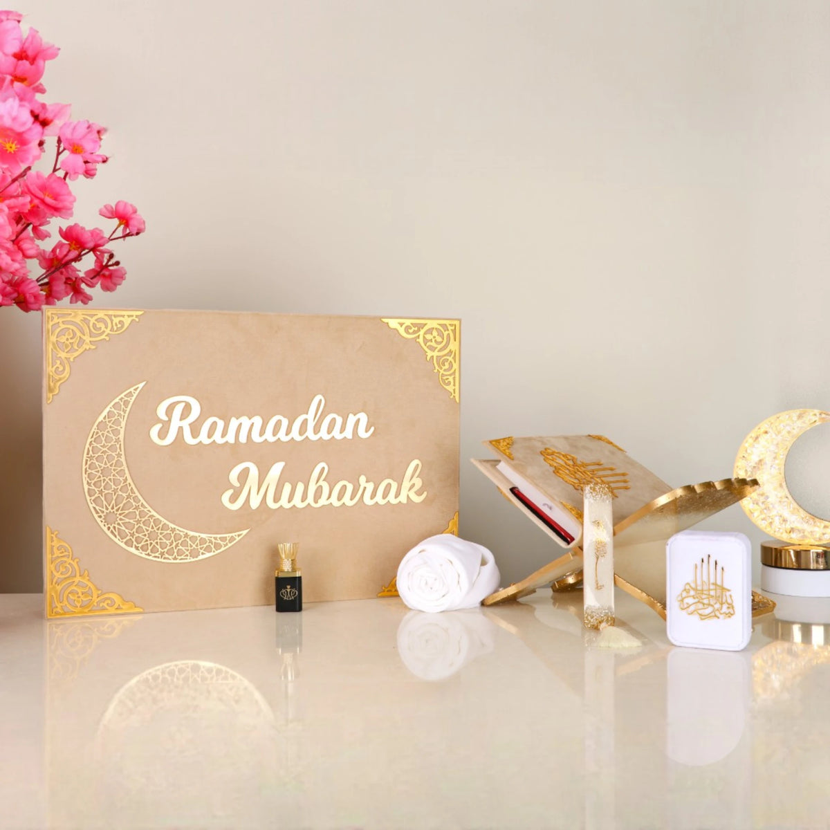 Beige Jannah Treasures Ramadan Hamper with gold 'Ramadan Mubarak' design, featuring Quran, tasbeeh, ittar, and prayer items for festive gifting.