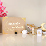 Beige Jannah Treasures Ramadan Hamper with gold 'Ramadan Mubarak' design, featuring Quran, tasbeeh, ittar, and prayer items for festive gifting.