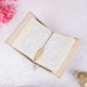 Kaaba Quran Premium displayed open with gold feather bookmark, surrounded by Islamic decor, ideal for gifting and prayer rituals.