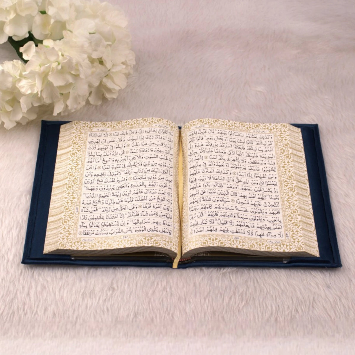 Open Quran with ornate border design from the Blue Sequence Rehal Hamper, perfect for decorative Islamic gifting and personal devotion.