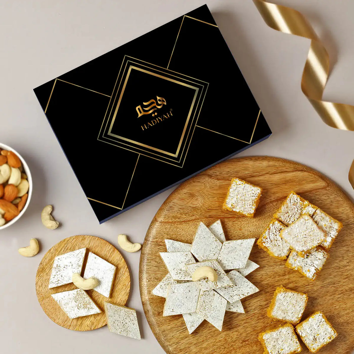 Kaju Katli & Moong Dal Barfi Combo - 400g box with diamond-cut Kaju Katli and square Moong Dal Barfi on wooden trays, ideal Indian sweets gift set.