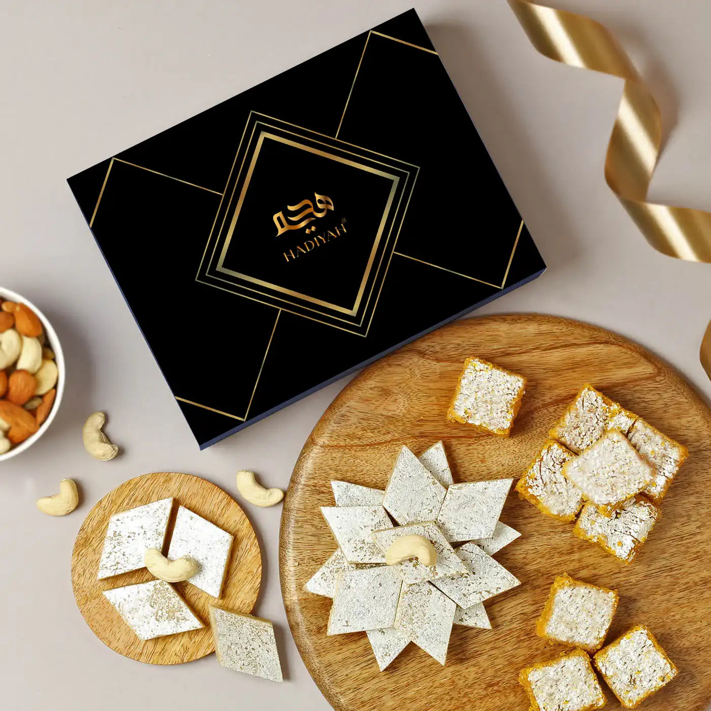 Kaju Katli & Moong Dal Barfi Combo - 400g box with diamond-cut Kaju Katli and square Moong Dal Barfi on wooden trays, ideal Indian sweets gift set. Main image