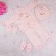 Pink baby outfit set with matching accessories on a light gray background