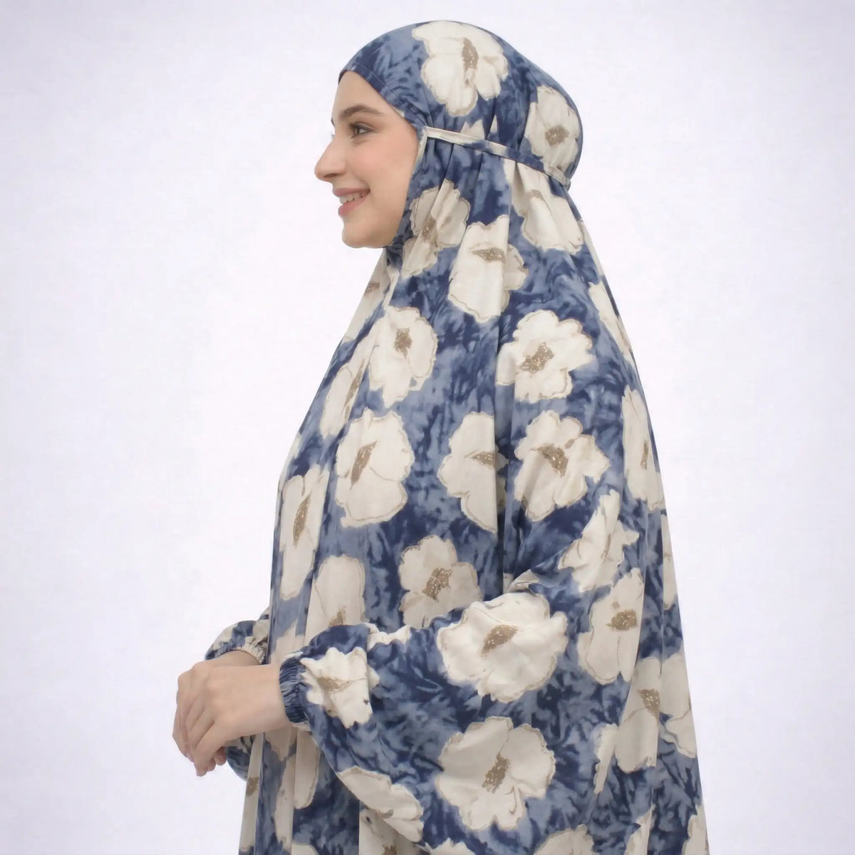 Side profile of woman wearing floral prayer dress with head covering