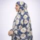Side profile of woman wearing floral prayer dress with head covering