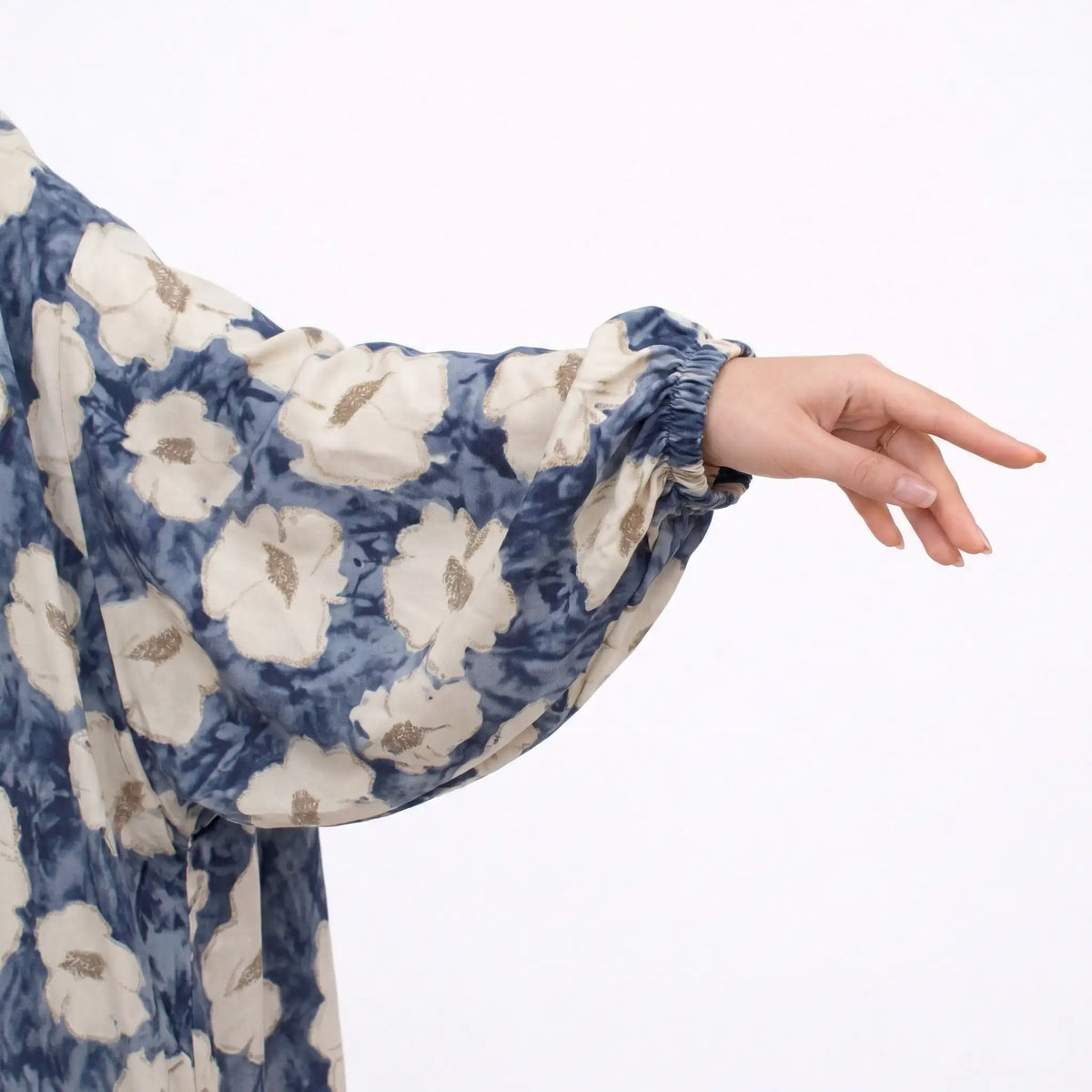 Close-up of floral printed prayer dress fabric with gold accents