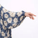 Close-up of floral printed prayer dress fabric with gold accents