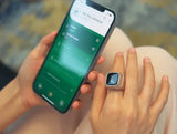 Person using smartphone app synced with rose gold Zikr Ring with 99 Zirconia. Smart Islamic ring for digital tasbeeh and prayer tracking.
