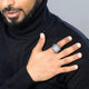 Man wearing Zikr Ring with 99 Zirconia on right hand, styled with black turtleneck. Stylish religious gift for men and prayer use.