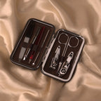 Luxury compact grooming kit with nail clippers, scissors, and tweezers in a brown leather case. Ideal for personal care during Hajj & Umrah.