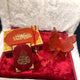 Decorative items including a red butterfly ornament and a small book with gold text on a white fur background.