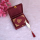 Mini Tilawat-e-Quran in maroon velvet case with gold accents and feather tassel bookmark, placed inside an open velvet gift box. Perfect ceremonial gift.