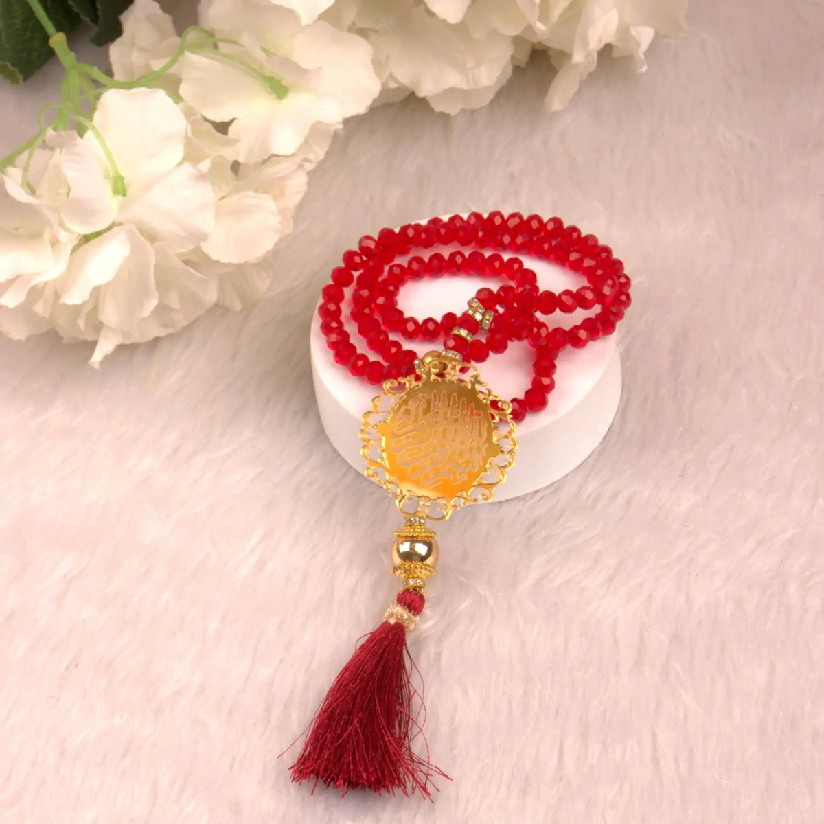 Red Tasbeeh with gold detailing and tassel, included in the Maroon Flakes Bridal Hamper, perfect for bridal religious gifting.