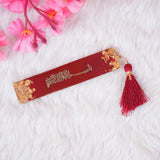 Maroon resin bookmark with tassel, included in the Maroon Flakes Bridal Hamper, ideal for Quran reading and bridal gift sets.
