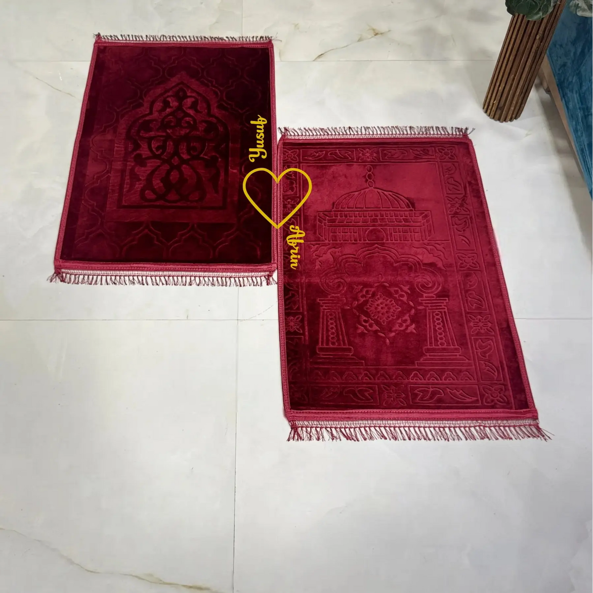 Detailed maroon prayer mats with Islamic patterns from Maroon Bridal Hamper - Sawab-e-Jariya, ideal for wedding and couple gifting.