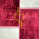 Couple Janamaz Prayer Mat in maroon shades with heart design and personalized names, made from soft, durable fabric for Islamic wedding gifts.