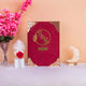 Red velvet Whispering Flowers Nikah Nama with gold embossed initials and ornate Islamic design, a luxurious wedding gift option.
