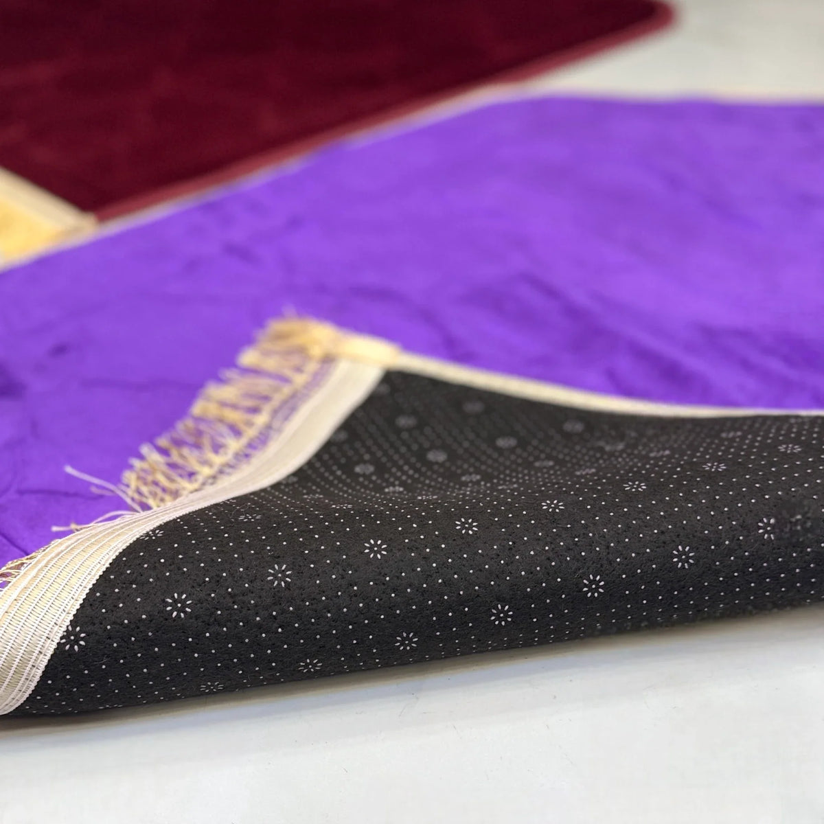 Underside of purple prayer mat from Maroon & Purple Couple Dome Janamaz Set, showing anti-slip backing and quality craftsmanship.
