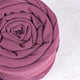 Rolled-up pink fabric on a white background