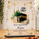 Personalized Hajj mubarak plaque with floral design on a wooden surface.