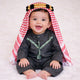 Baby boy in traditional red and white keffiyeh with black thobe on white fluffy background