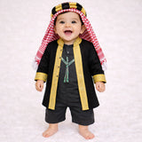 Baby boy in traditional black and gold Islamic outfit with red and white headscarf