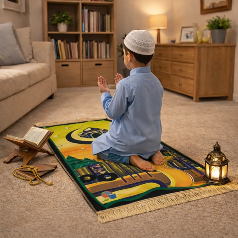 Kids Prayer Mat - Personalized Mat | Janamaz for Kids featuring a boy praying on a colorful Islamic-themed mat with Kaaba design in a cozy living room. Main image