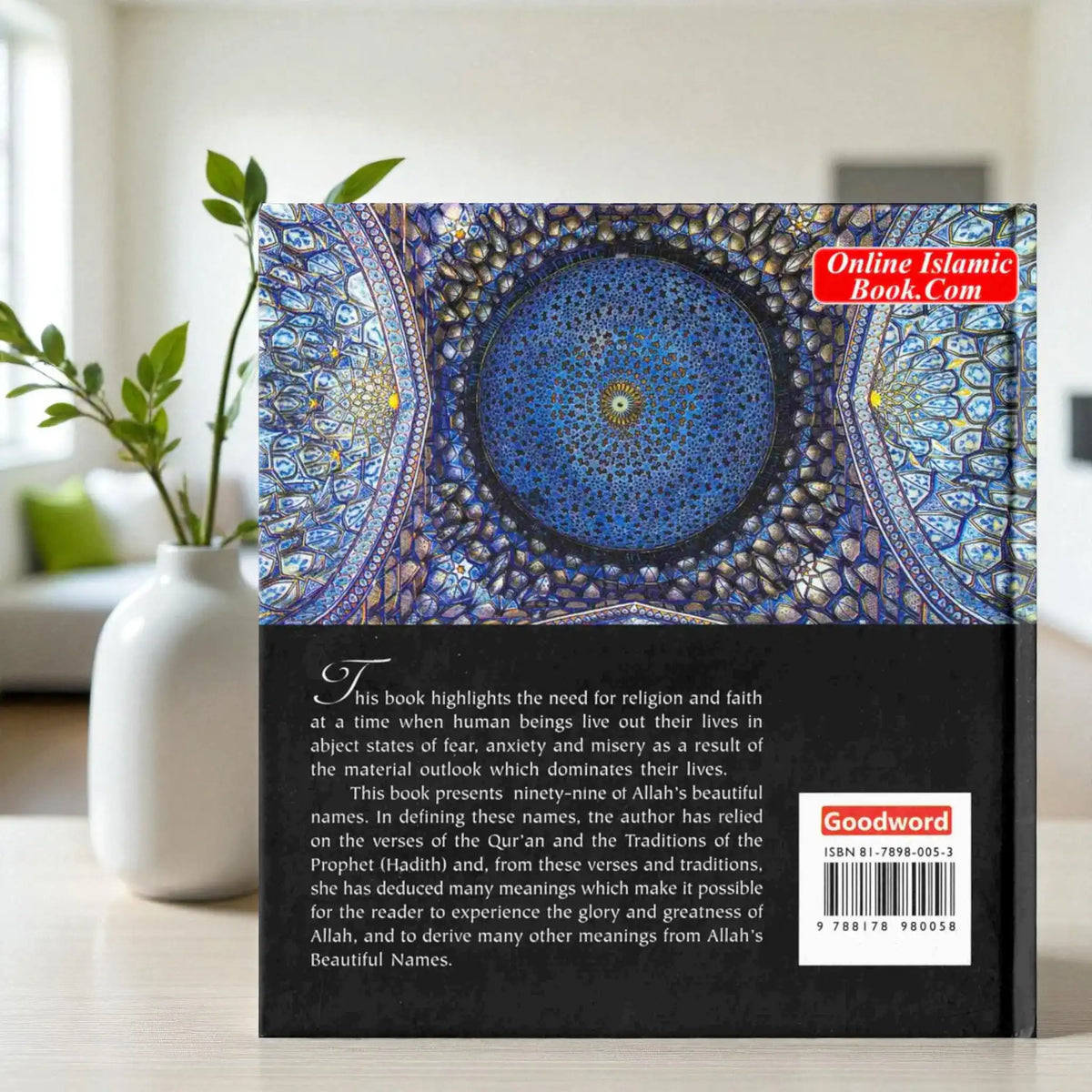 Book cover with intricate design and text on a table with a vase and plant in the background
