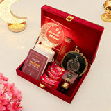 Decorative gift set with candles, cards, and decorative items in a red box.