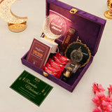 Gift set with Ramadan-themed items including a book, lantern, and decorative items on a light background.