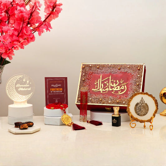 Elegant Mubarak Moments Ramadan Gift Box featuring spiritual items like prayer beads, Islamic book, and decor in red velvet packaging.