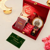 Decorative Ramadan gift set with red box, cards, and decorative items on a light background.