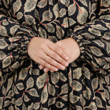 Close-up of hands with a floral patterned garment