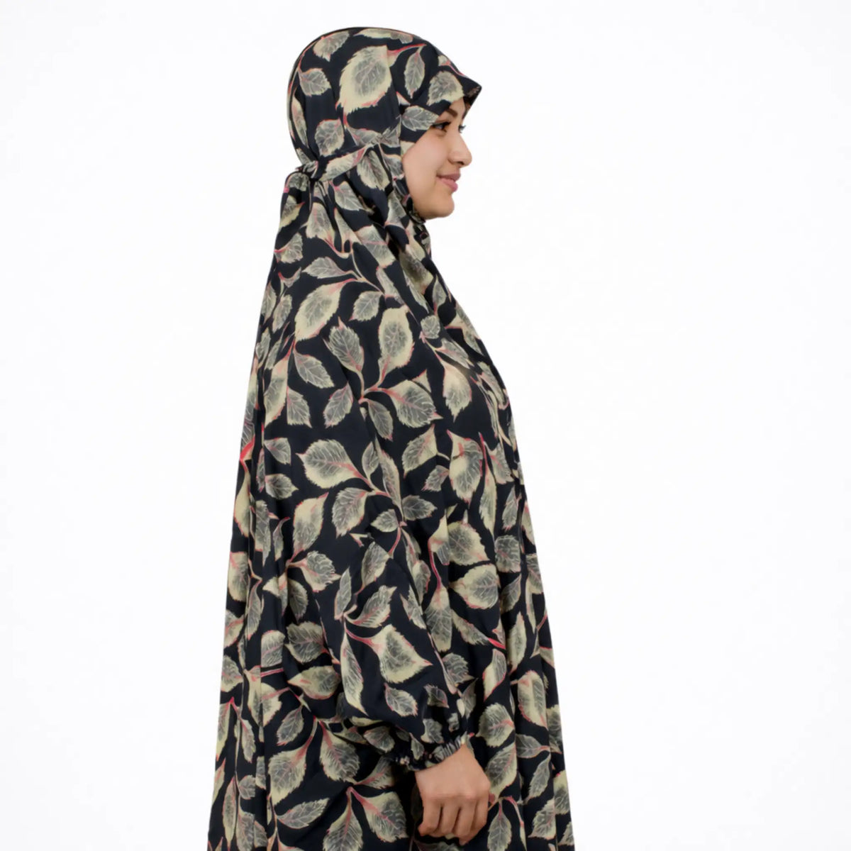 Person wearing a patterned hijab and dress on a white background