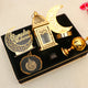 Nazakat Luxury Ramadan Hamper arranged in a black velvet tray with moon lamp, gold lantern, bakhoor burner, and Islamic ornaments for Ramadan gifting.
