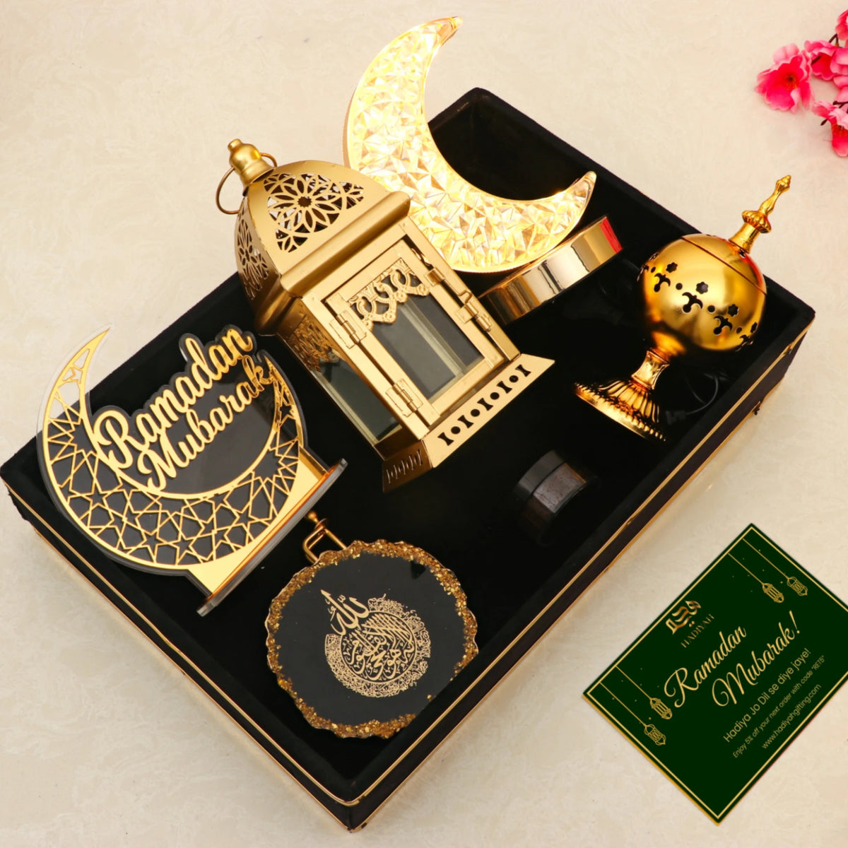 Nazakat Luxury Ramadan Hamper with moon lamp, gold lantern, and Islamic decor in a velvet tray, includes a Ramadan Mubarak greeting card for gifting.
