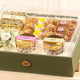 Close-up of Nazrana-e-Tohfa Set featuring gourmet sweets, nuts, and elegant jars in a premium green gift box for festive gifting.