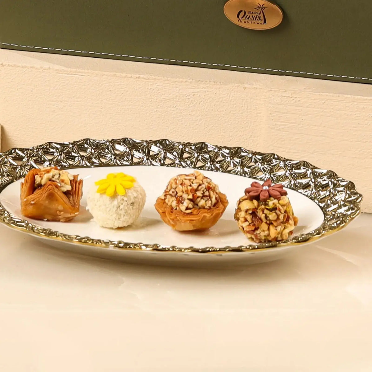 Plated selection from Nazrana-e-Tohfa Set showcasing baklava, coconut sweet, and nut-covered delights for festive gourmet gifting.