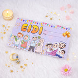 A single light purple Eidi gift envelope featuring the word 'EIDI' in bold yellow letters and cartoon illustrations of a Muslim family celebrating. The envelope is displayed on a soft white faux fur surface, styled with a lit tea light candle, scattered golden star confetti, a crescent moon charm, and a pink flower.
