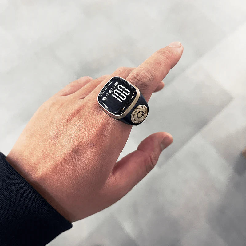 Noor Zikr Ring 2.0 worn on hand, displaying digital prayer count with app integration for engaging zikr tracking. Main image