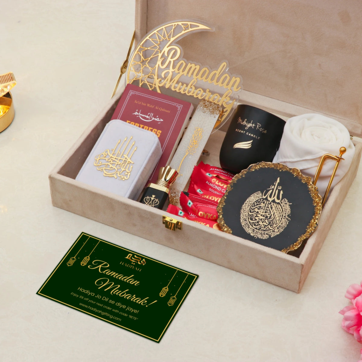Open Noor Al-Ramadan Gift Box displaying tasbeeh, prayer book, candle, hijab, and Islamic decor, ideal for Ramadan celebrations.