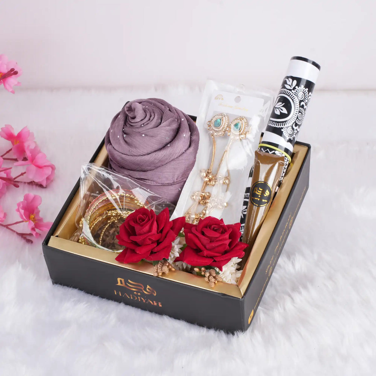 EID gift hamper with hijab, jewelry, and flowers