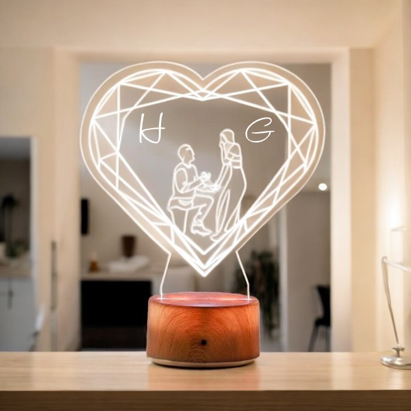 Personalized Noor-e-Mohabbat LED Lamp featuring couple silhouette and initials H and G, ideal anniversary or wedding gift with warm wooden base.