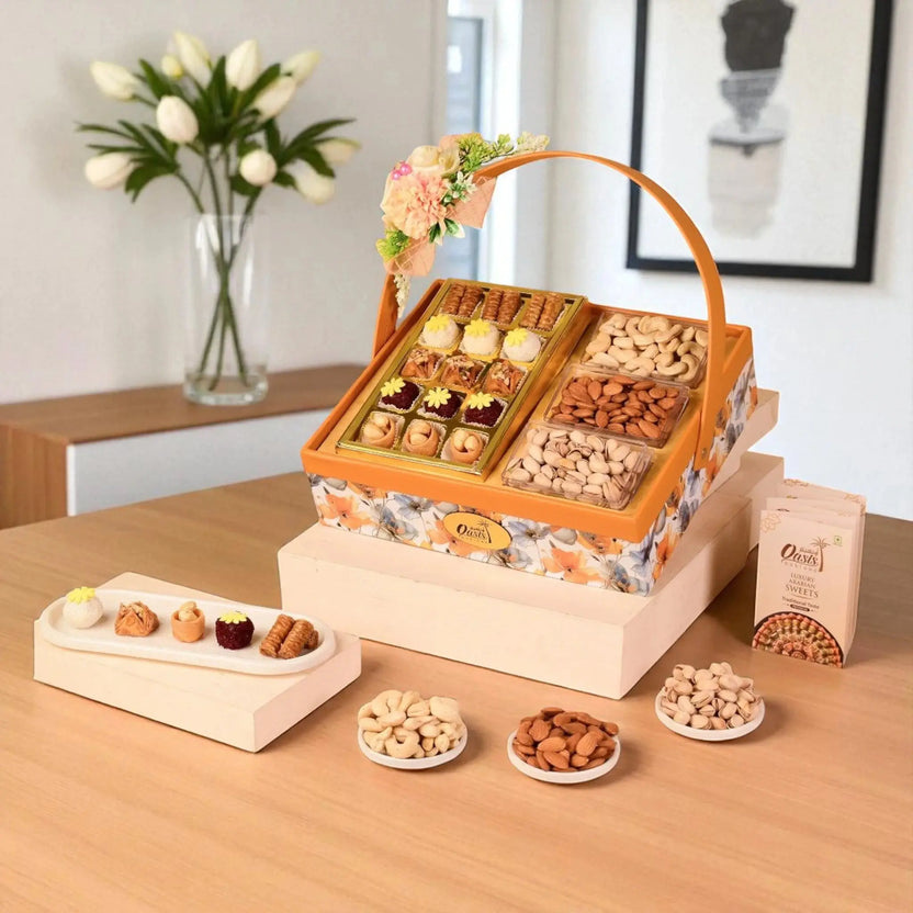 Bites of Celebration Basket - Gourmet Gift Basket featuring baklawa, fusion sweets, plain cashews, salted pistachios, almonds, and walnuts in a floral box. Main image