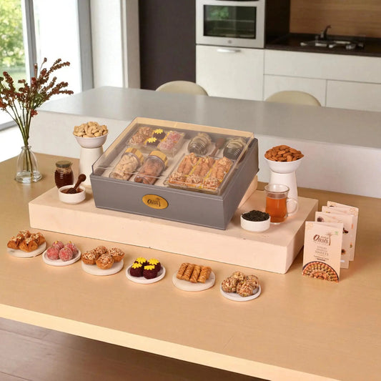 The Regal Treat Box - Elegant Festive Sweets Hamper featuring assorted baklawa, fusion balls, dry fruits, and tea, ideal for gifting occasions.