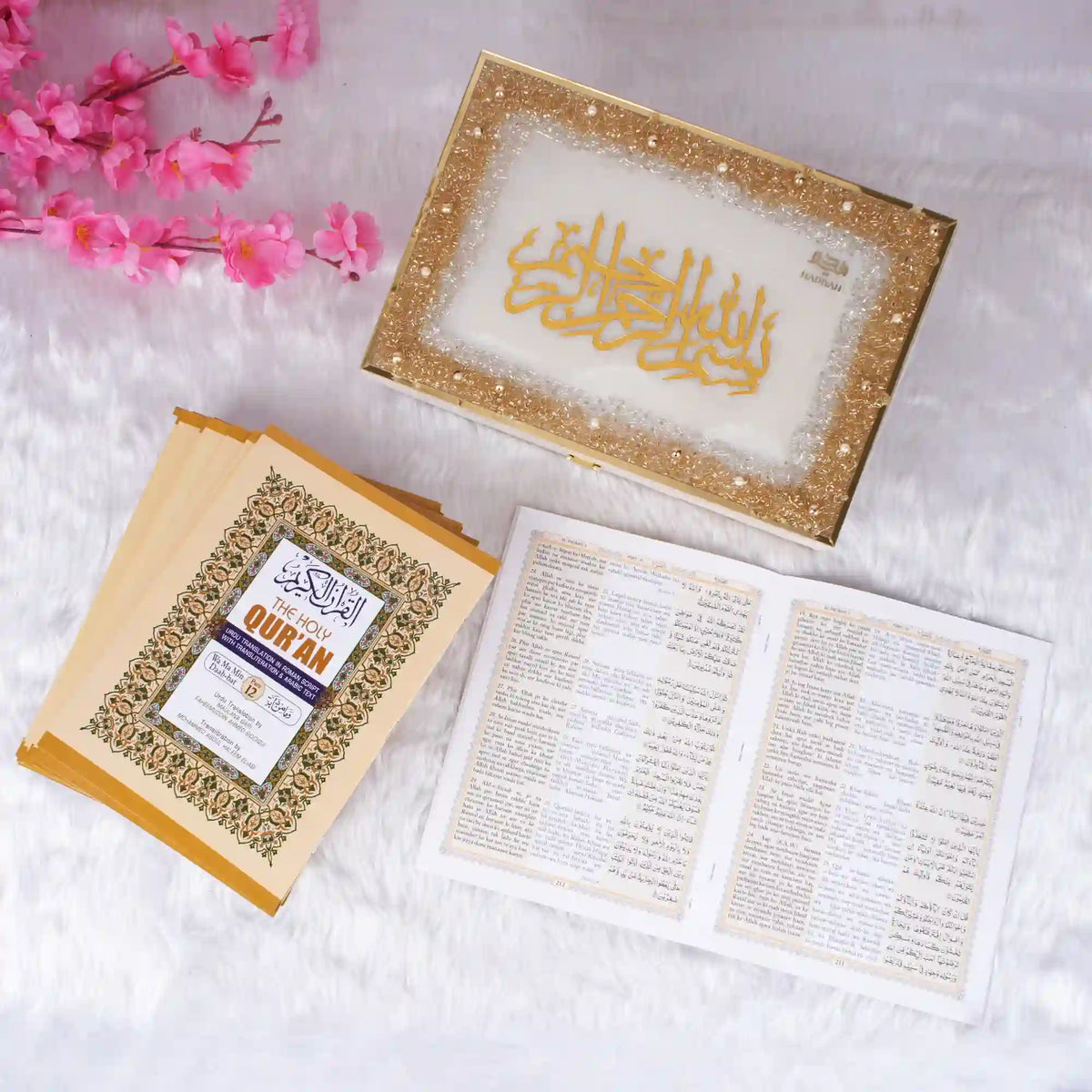 Golden framed Quran with pink flowers