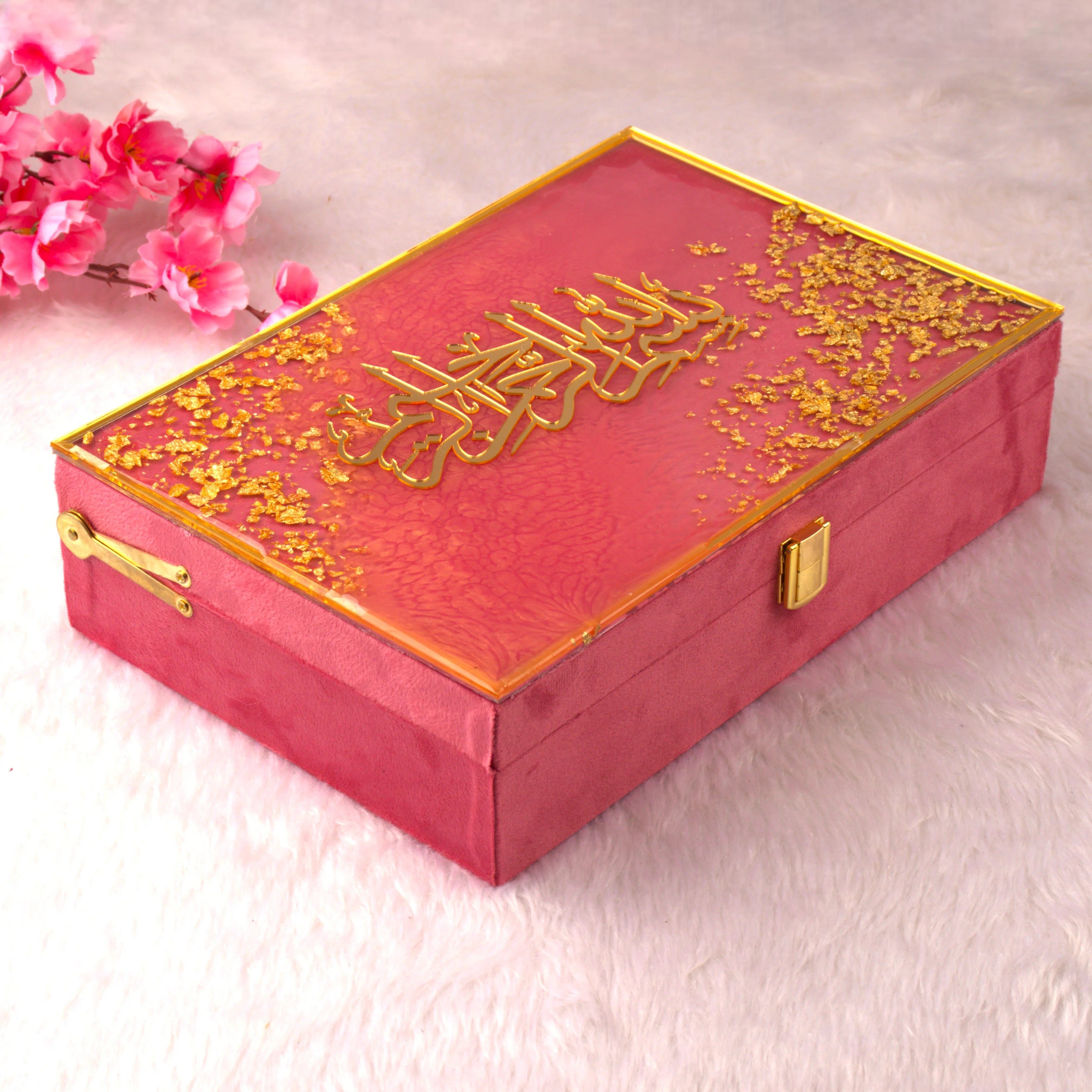 Decorative red box with gold accents and floral elements on a light background