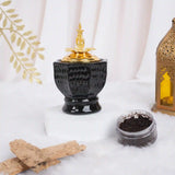 Obsidian Royale Bakhoor Burner with gold lid, ideal for Ramadan & EID home decor, placed on white fur with incense and lantern accents.