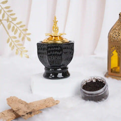 Obsidian Royale Bakhoor Burner with gold lid, ideal for Ramadan & EID home decor, placed on white fur with incense and lantern accents.