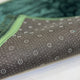 Non-slip backing of green Janamaz from the Couple Janamaz Set, featuring dotted grip for stability and comfort during prayer.
